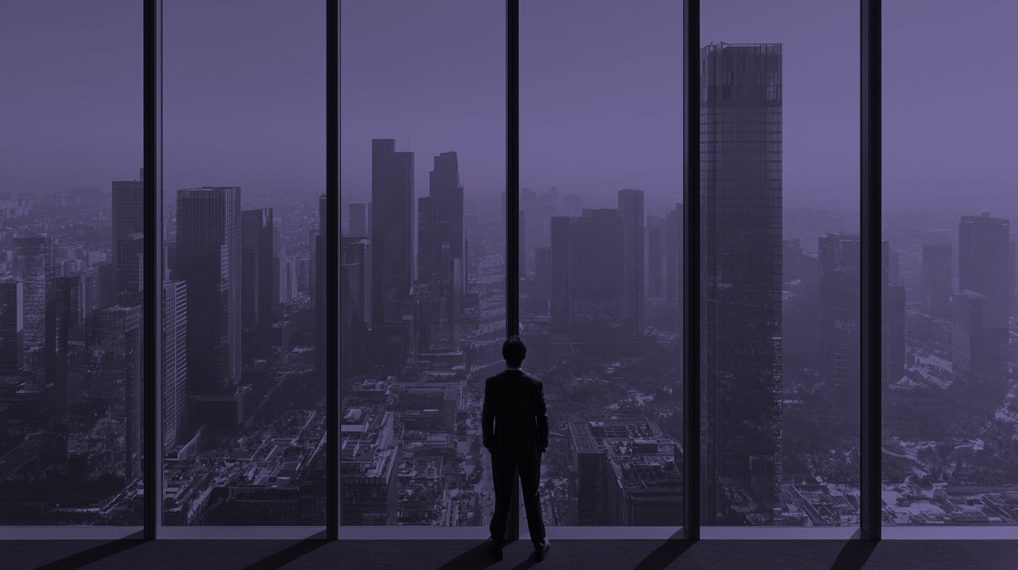 A leader looking out over a city skyline at dusk